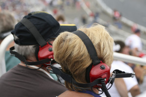 Couple wearing ear protection at NASCAR race