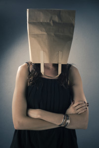 Woman with brown paper bag over head
