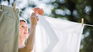 Woman hangs laundry on a line