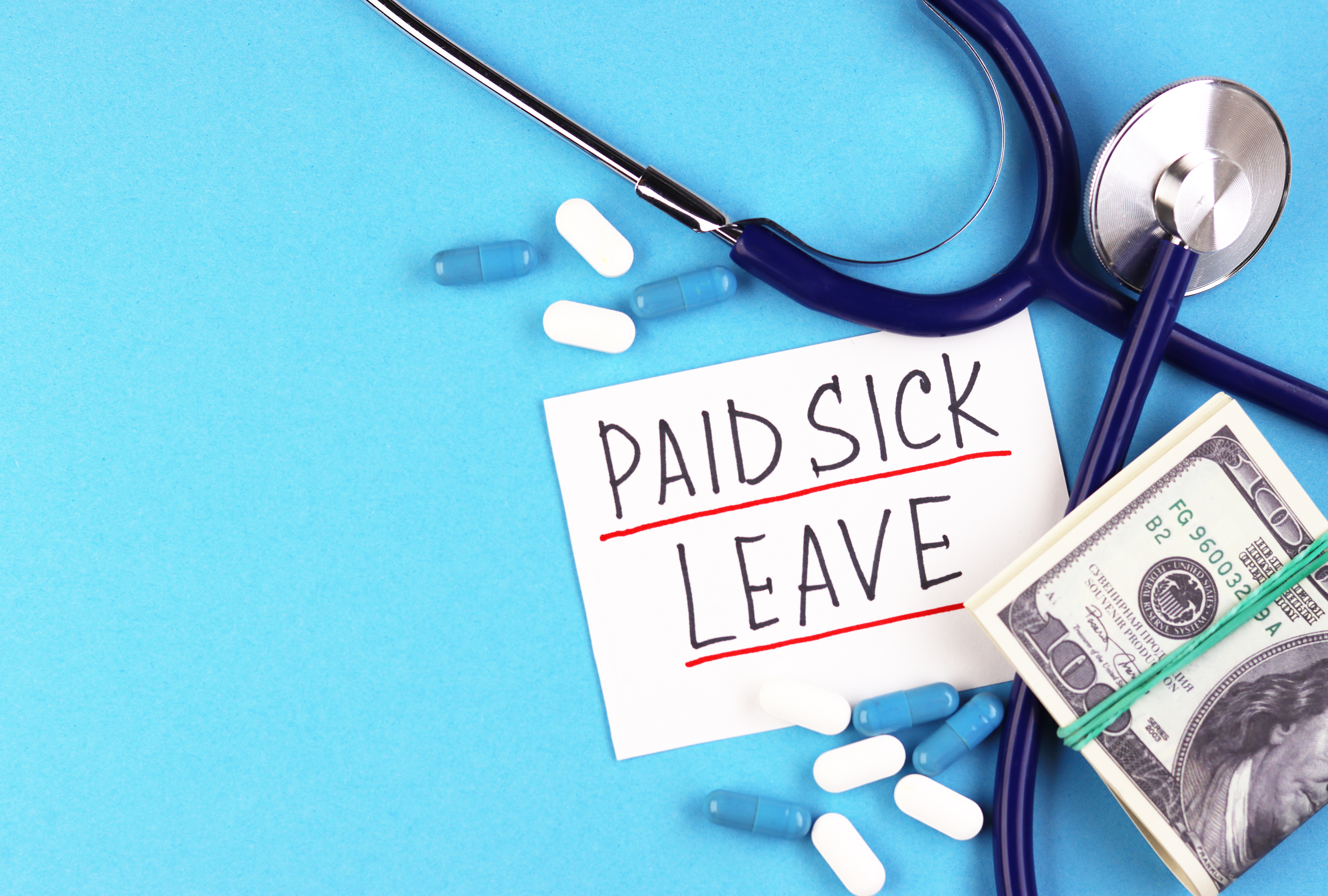 text paid sick leave and money with pills on a blue background