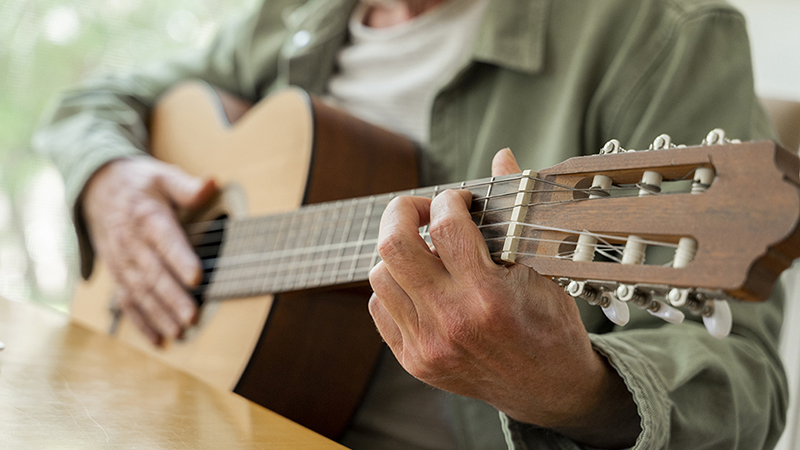 A close-up view of a man playing a guitar