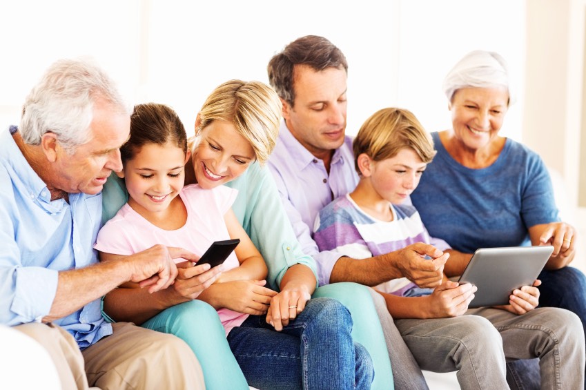 Three Generation Family Using Smart Phone And Digital Tablet