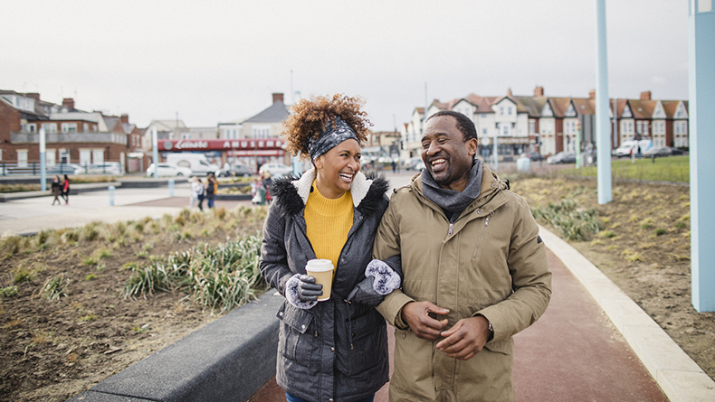 Black woman and man walk in neighborhood