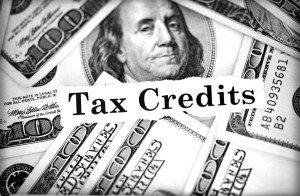 Pile of hundred dollar bills around tax credits