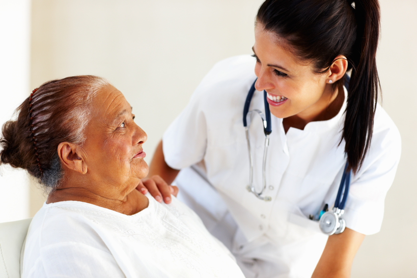 Doctor talking to older woman patient