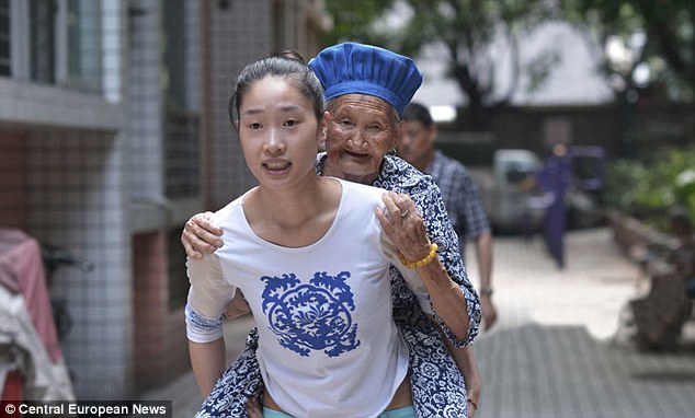 Chinese woman carrying her grandma