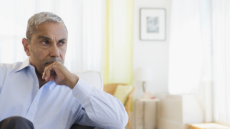 A man sitting in a home and thinking