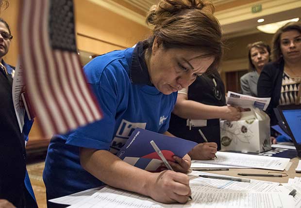 Caucusgoers check-in before casting their vote for a Democratic presidential candidate ahead of the Nevada Democratic presidential caucus at Caesar's Palace in Las Vegas, Nevada, U.S., on Saturday, Feb. 20, 2016. Today voters weigh in on the Democratic battle between Hillary Clinton and Bernie Sanders competing in the Nevada caucuses with Clinton believed to have the advantage in the western state because of its heavily Hispanic electorate, but some recent polls show the race tied.