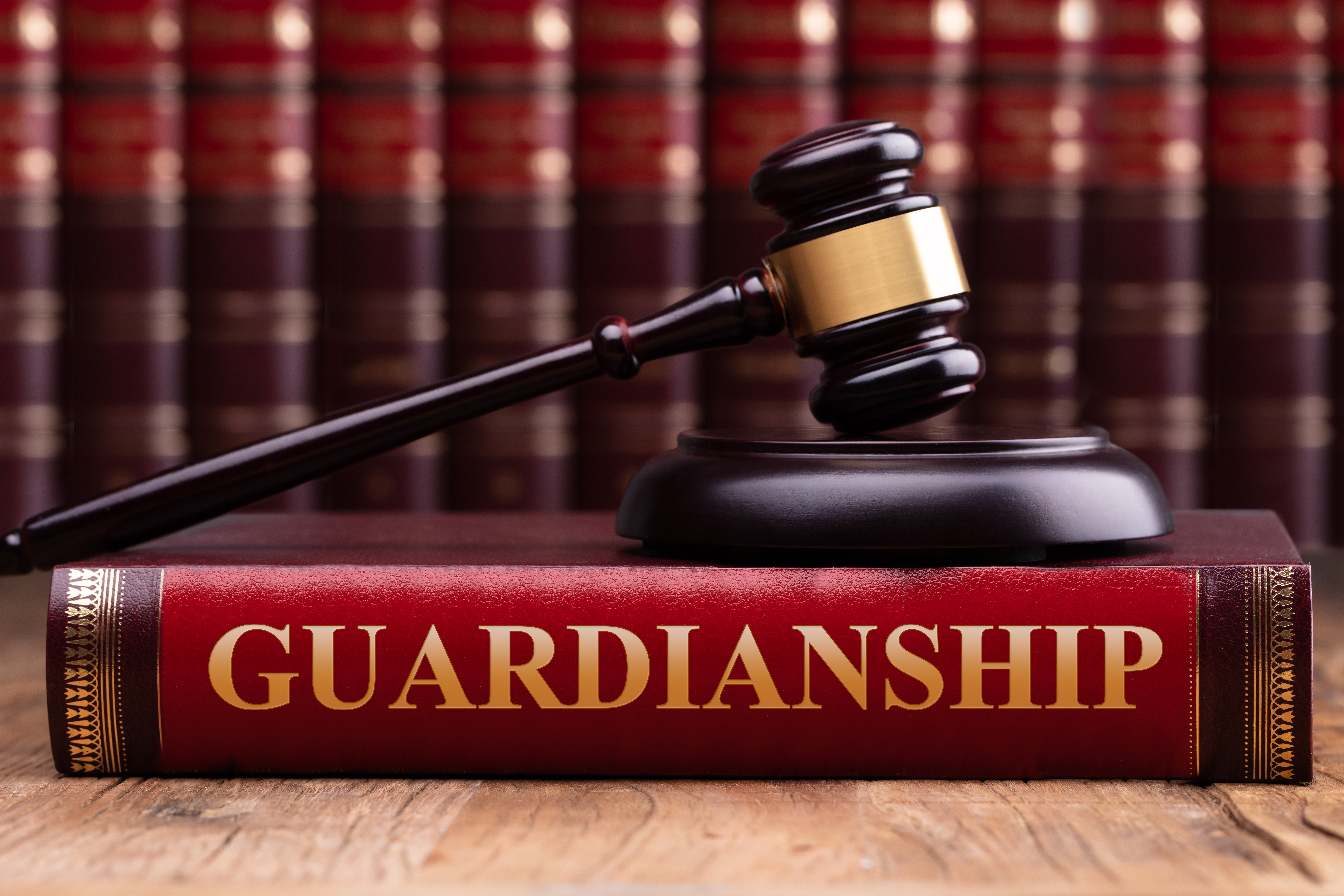 Gavel And Striking Block Over Guardianship Law Book