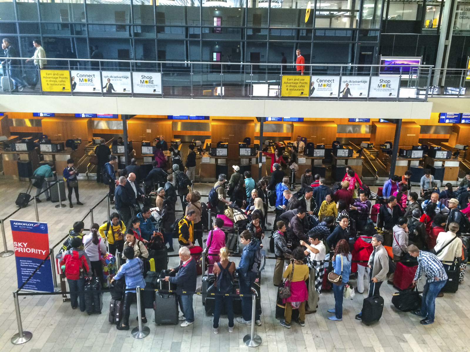 People waiting to make check-in for their flight
