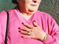 Hooked on Heartburn Medication- woman holding her chest in discomfort