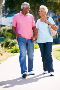 Senior African-American Couple Walking In Park Together