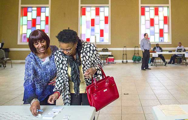 Sandy Haddock and Shirlee McCleskey talk at the Cathedral of Praise church, a polling station in Nashville, Tenn.