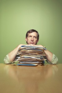 Man with piles of work