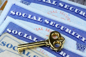 Gold key laying on social security card