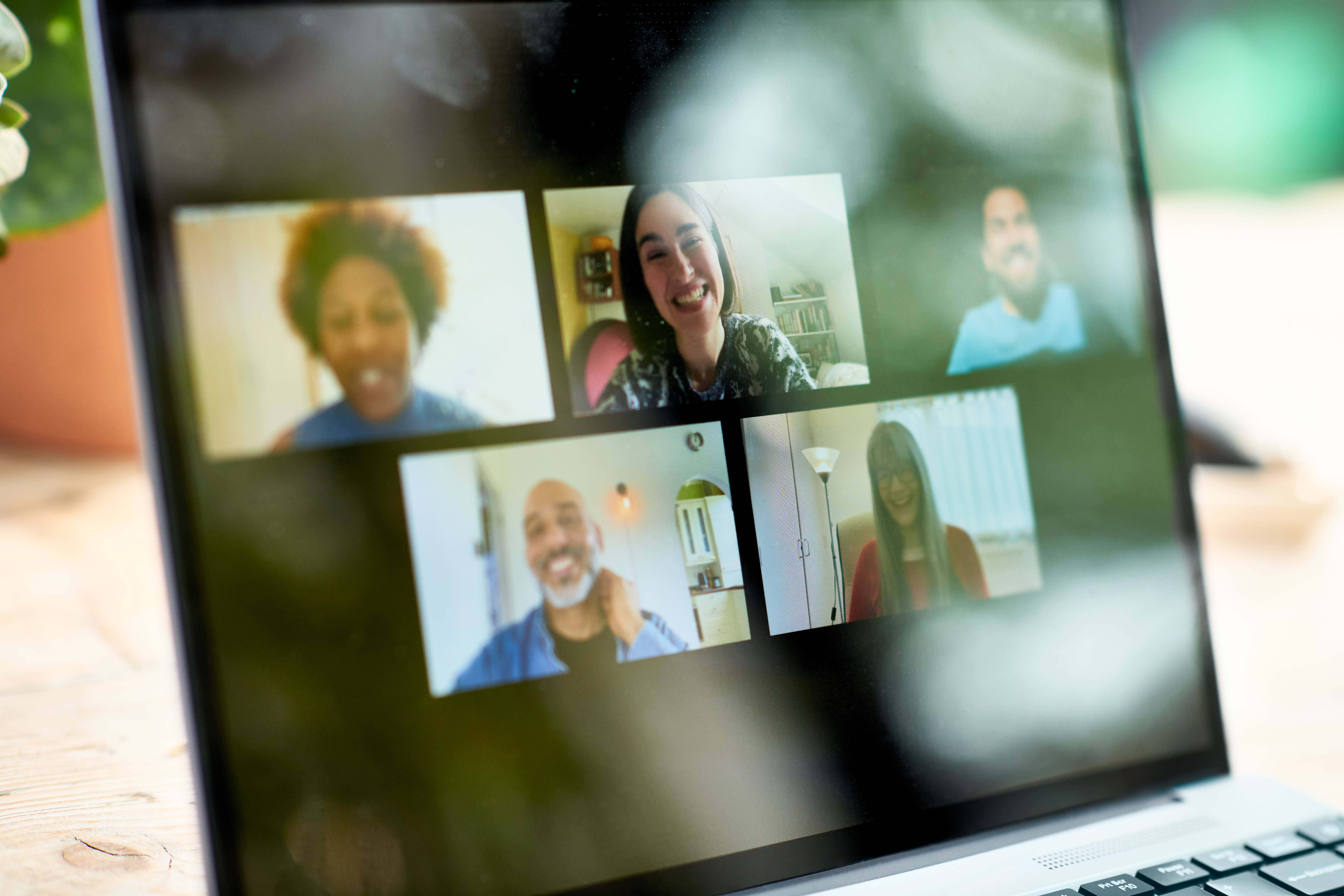 Smiling faces on laptop screen during video call