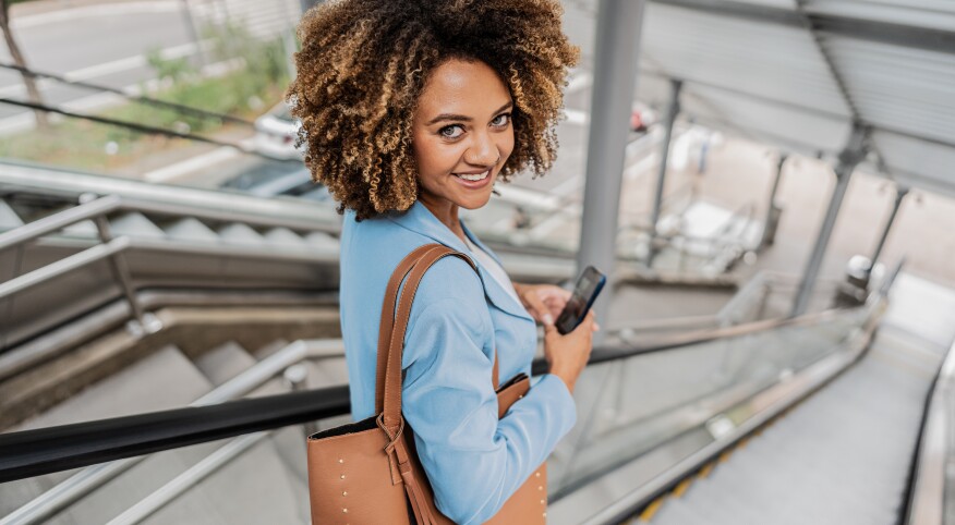 woman looking over her shoulder with large brown purse