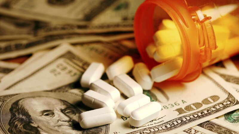 Prescription drugs on a hundred dollar bill