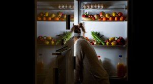 Woman looking in fridge for midnight snack