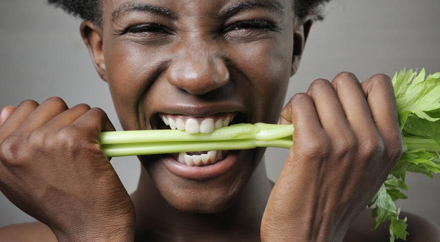 image_of_woman_holding_and_biting_down_on_celery_stalk_GettyImages-112507347_1800