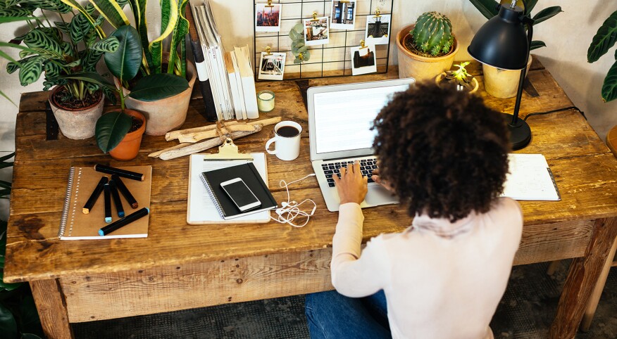 woman sitting at a desk working on a computer