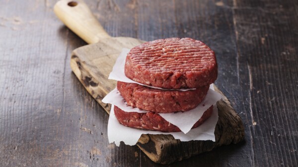 Raw Ground beef meat Burger steak cutlets on dark wooden backgro