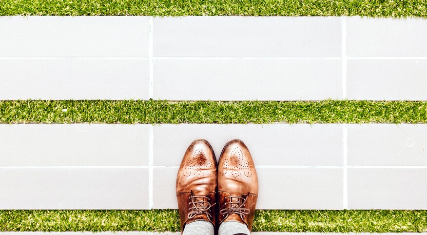 An image of a person's feet in Oxfords.