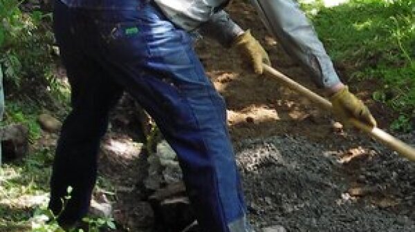 Volunteer works the soil