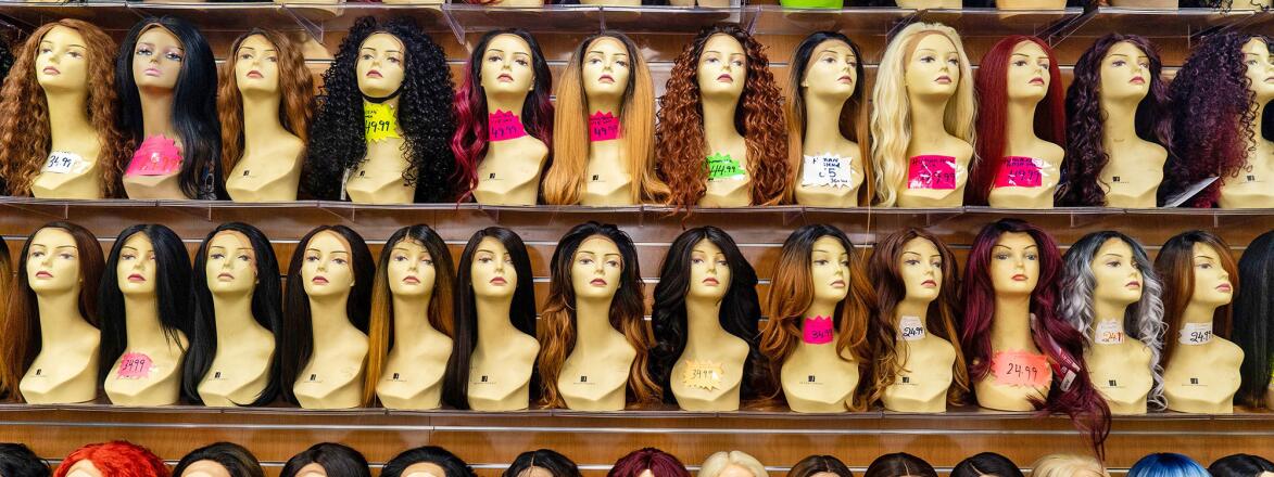 Mannequins with wigs on a shelf