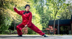 Tai Chi instructor doing moves in red, satin outfit