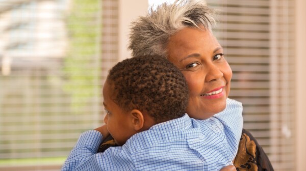 African American woman hugs grandson