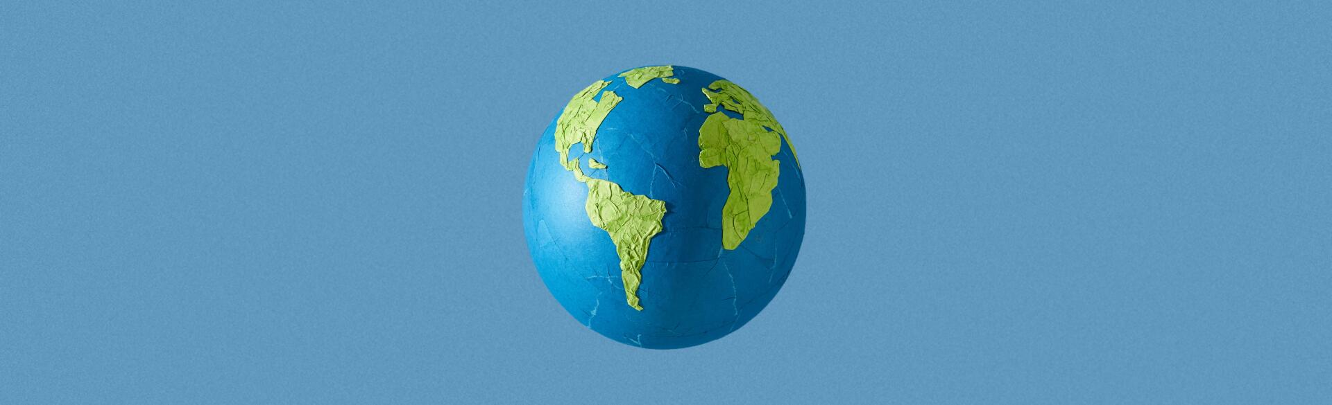 paper mache globe on blue background