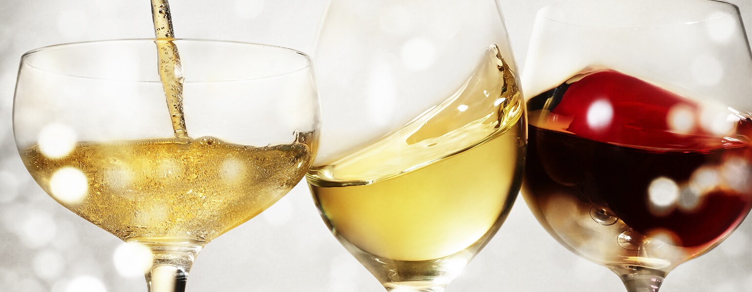 An image of three different holiday wines in wine glasses.