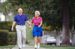 Senior couple walking side by side on sidewalk