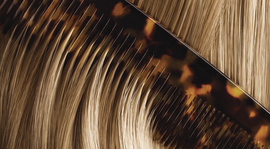 Close up of comb brushing blonde hair