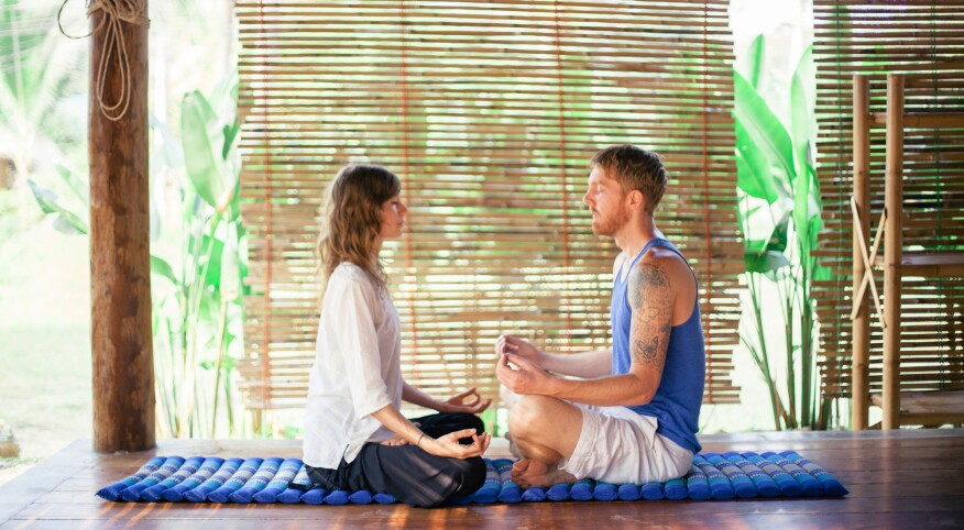 Couple meditating and doing yoga together