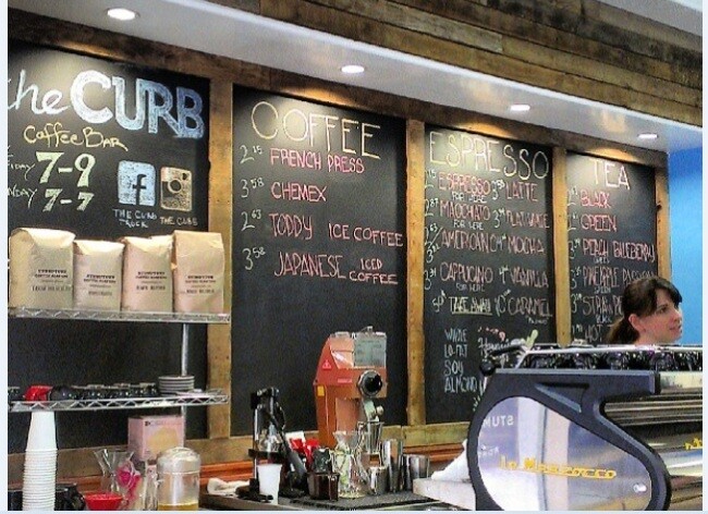 Barista Juli Burden works the counter at The Curb, a Honolulu coffee shop.