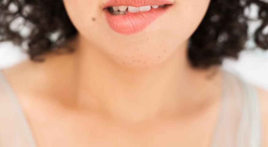 Up Close Of A Woman biting her lip