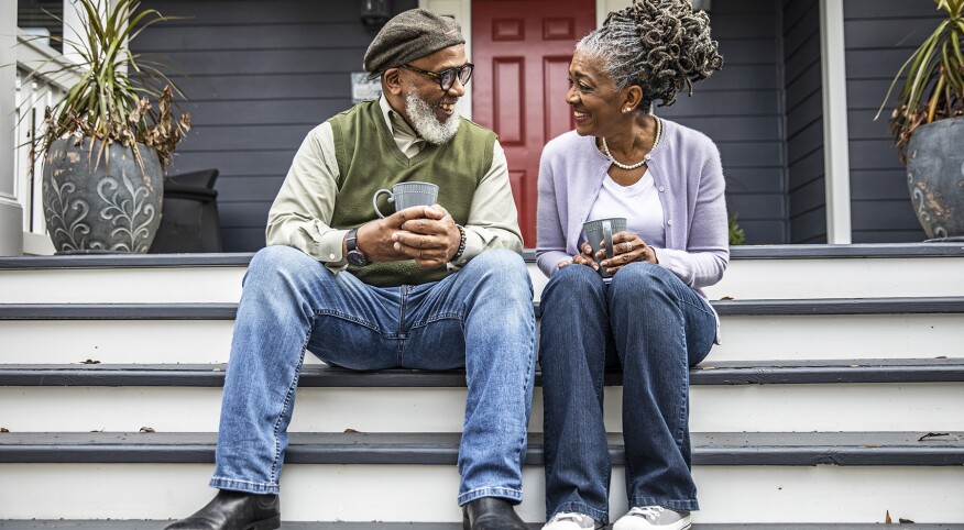 image_of_couple_sitting_on_front_porch_GettyImages-1355067016_1800