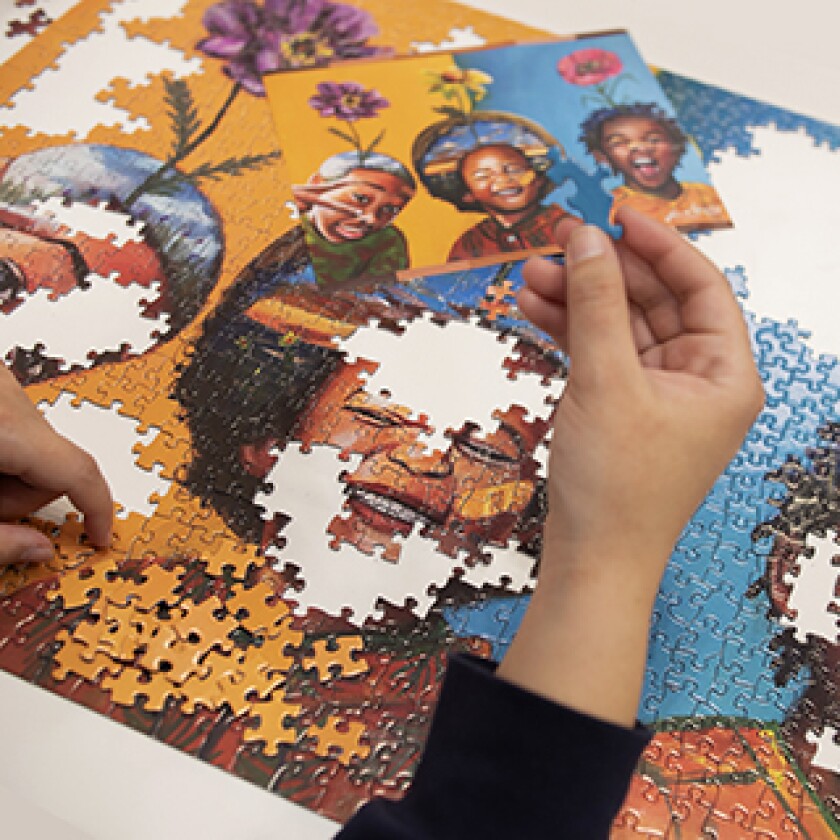 Close-up hand doing a puzzle