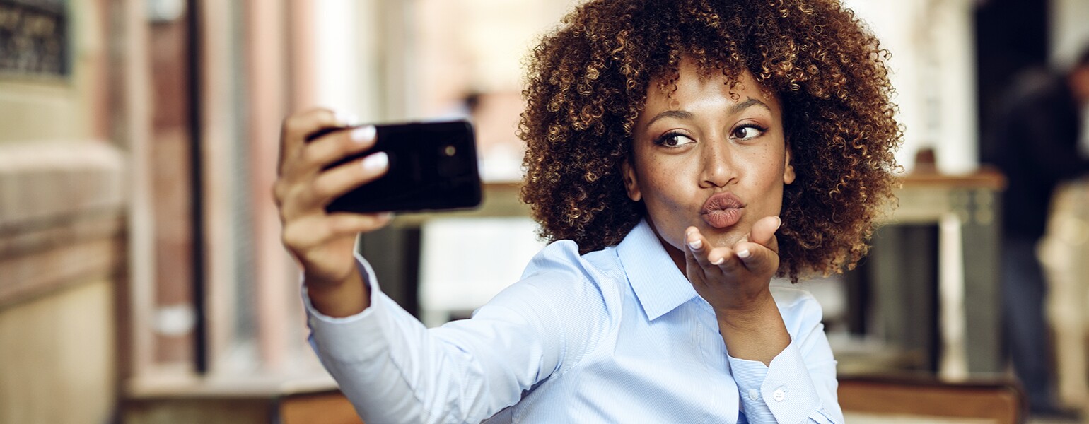image_of_african_american_woman_taking_selfie_with_phone_GettyImages-946920772_1540