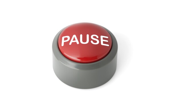 Red Circular Push Button Labeled 'Pause' on White Background
