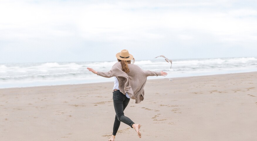 single woman running on the beach