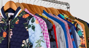 image of clothes on a rack by armoire