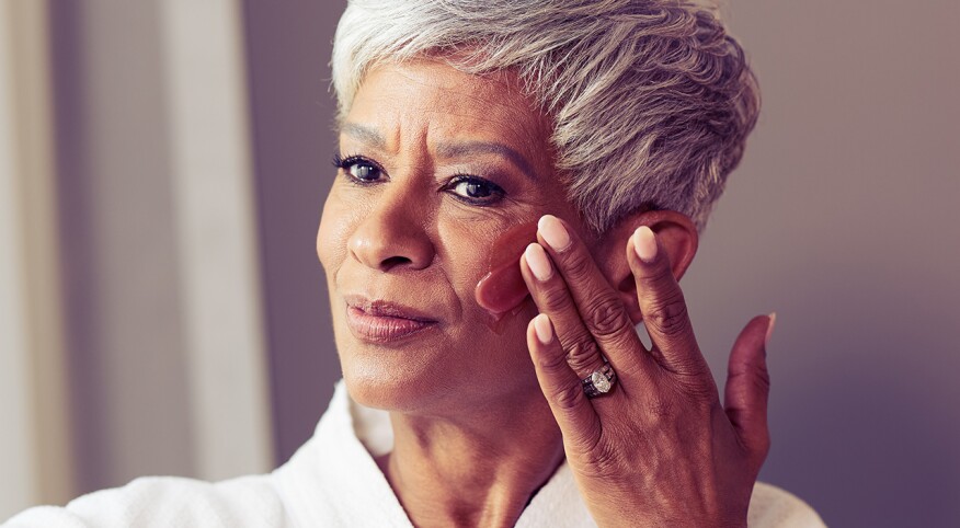 Woman applying face cream 