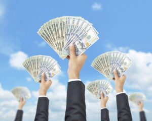 Crowdfunding hands holding up money