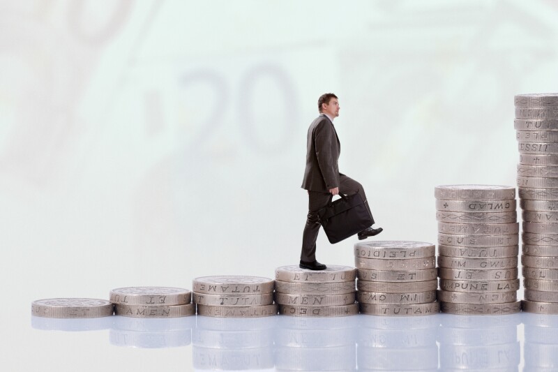 Businessman climbing money stairs