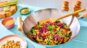 Stir fry in a wok with wooden spoon