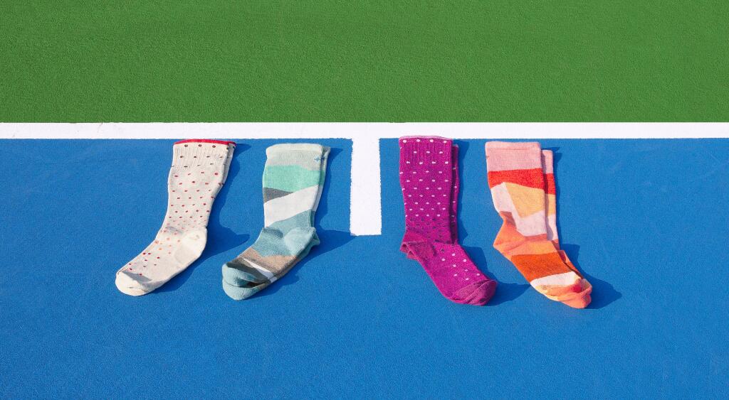 compression socks photographed on a blue tennis court