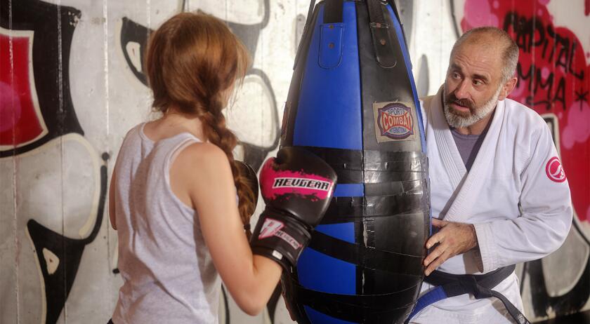 JayFerrari_TeachingDaughterToFight-JaredSoares1280x704.jpg Jay Ferrari and his daughters during their jiu jitsu training at his martial arts facility in Takoma Park, Maryland.
